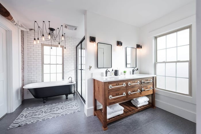 Bathroom remodel with claw-foot tub and black finishes.